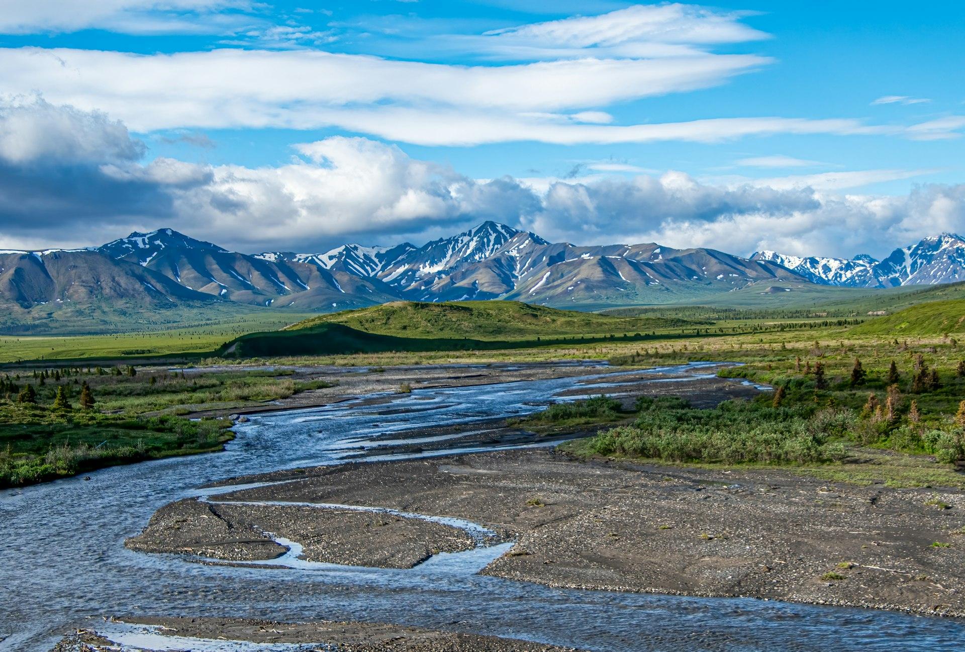 A braided river winding through a wide Alaska valley