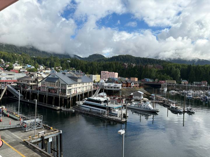 Boats in a harbor with buildings on stilts