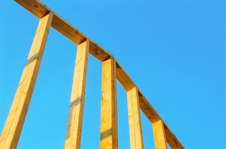 Wood wall framing against a blue sky